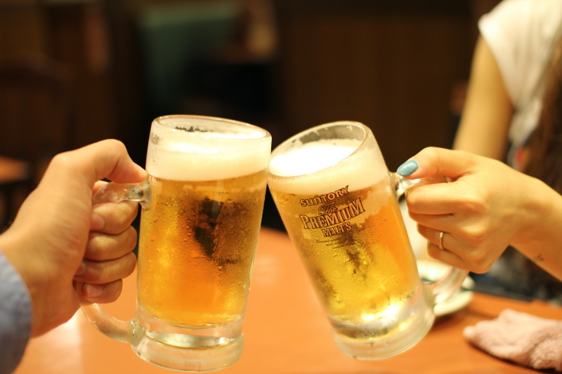 2 pints being clinked in a pub
